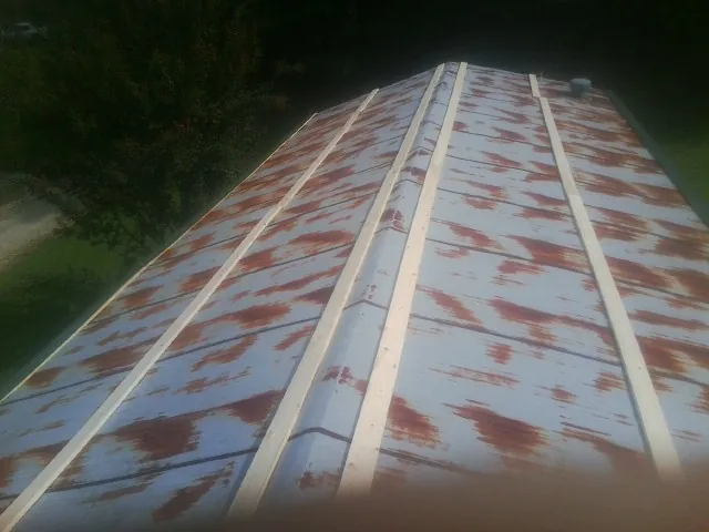Rusted metal roof panels with new wood purlins before replacement — Storm Damage Roof Repair in Nevada by Roofing Brothers